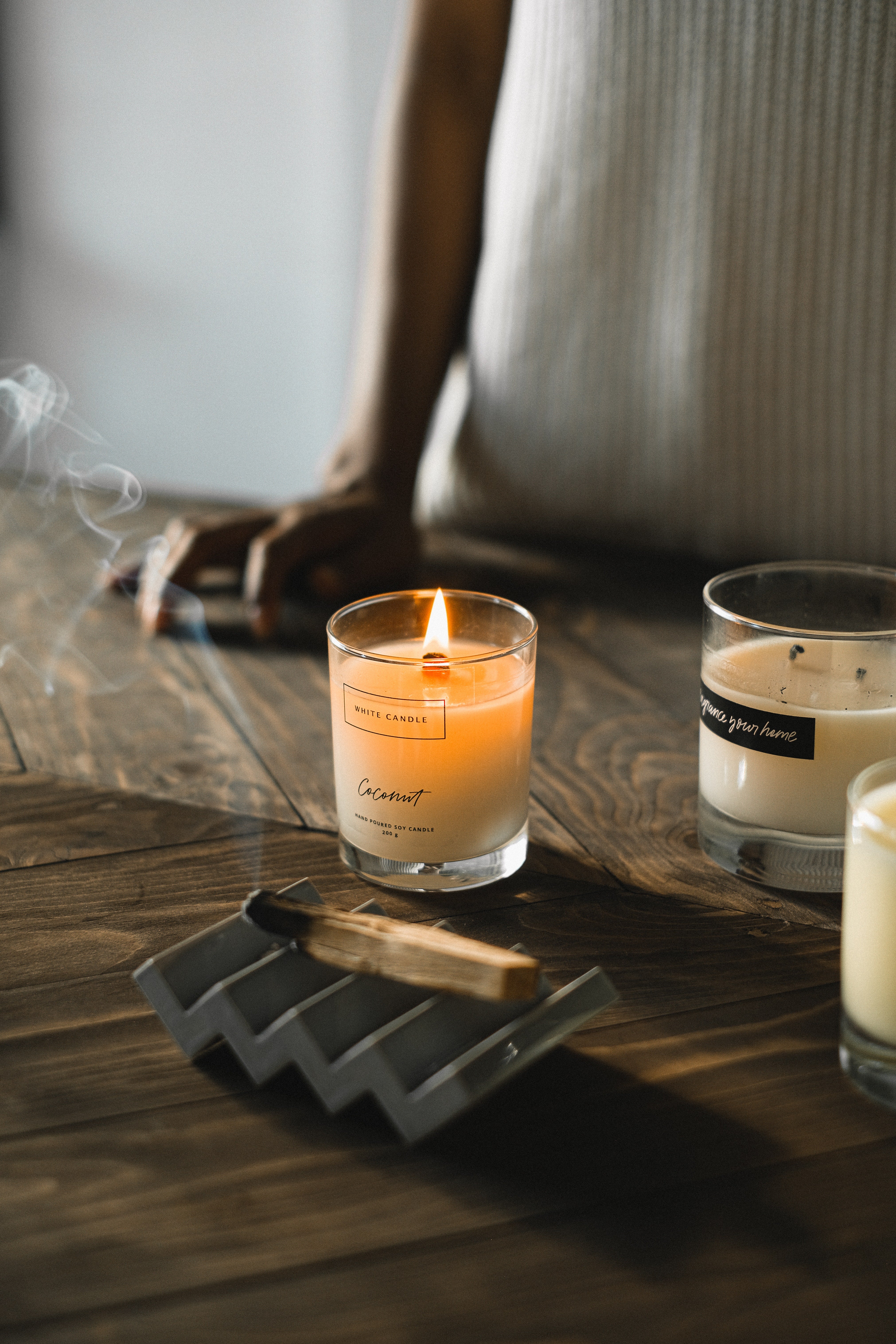 There are three candles on the table, one of which is lit