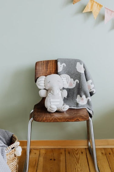 Plush elephant on a wooden chair