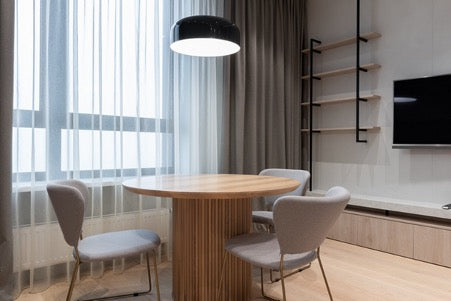 Round table and chairs near the window in the living room