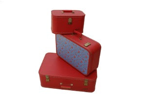 Three red suitcases on a white background