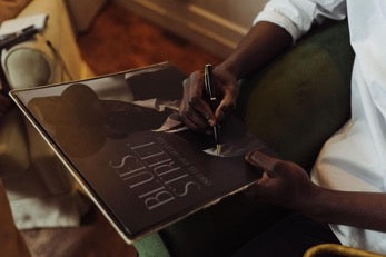 Hand with a pen signs the packaging of the record