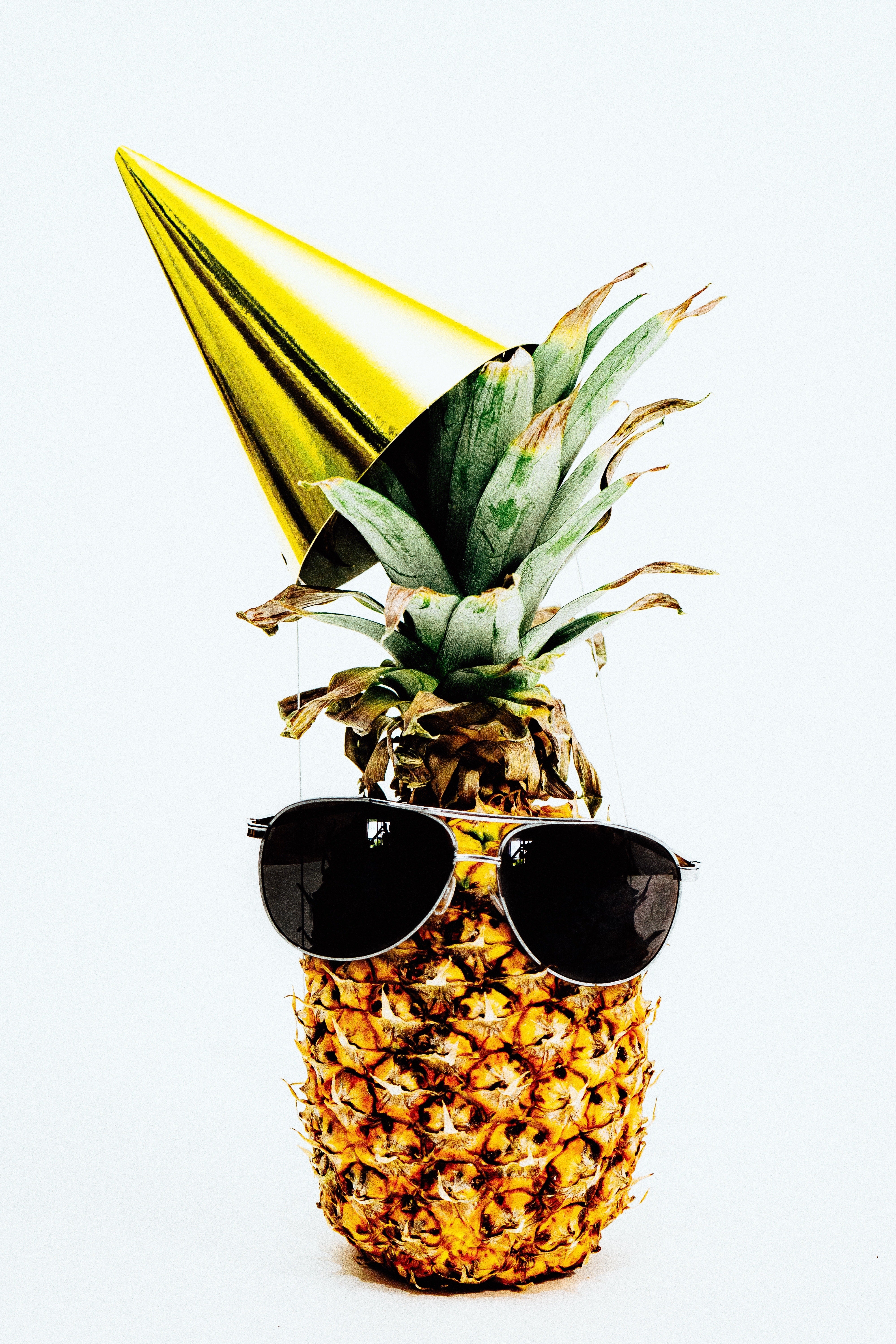 Pineapple in sunglasses and party hat