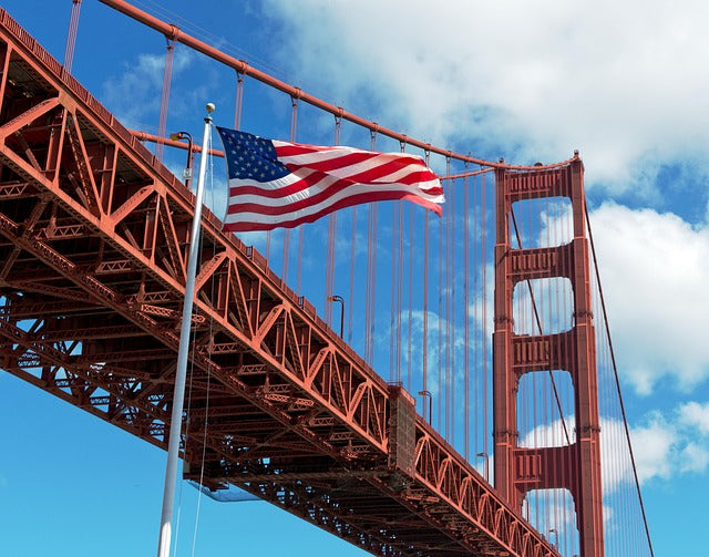 Bridge and USA flag against the sky