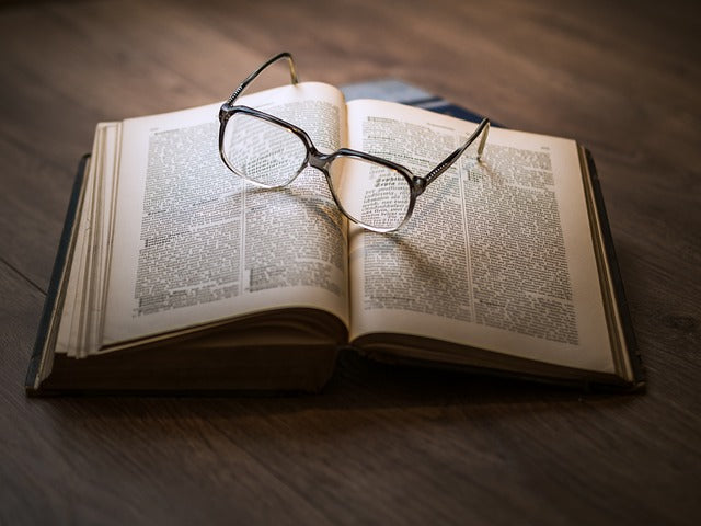 Glasses lie on an open book