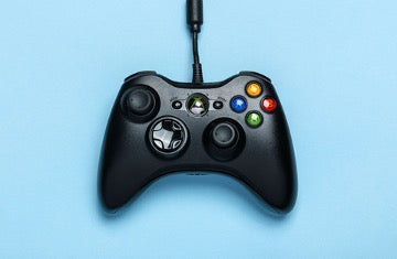 Black joystick on blue background