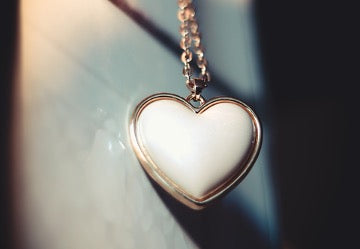 White heart pendant on a gold chain