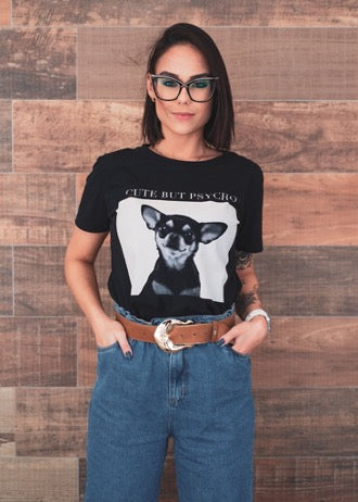 Girl in a black T-shirt with a print of a dog, blue jeans and glasses in black frames