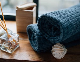 Two blue towels on a wooden table