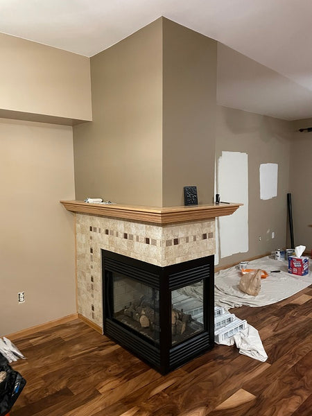 Peninsula fireplace with ceramic tile and oak mantel before remodeling. 