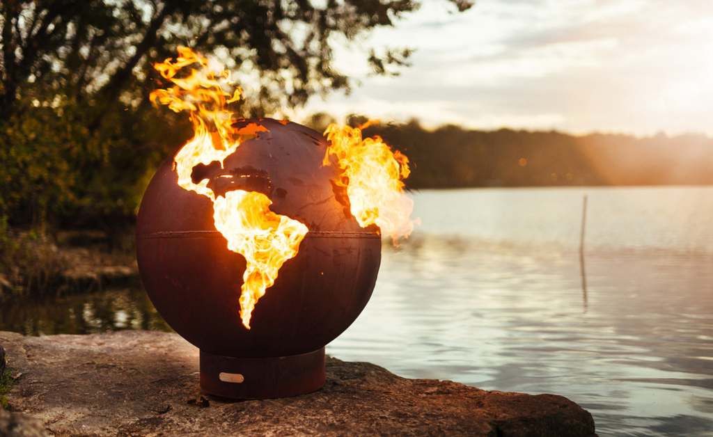 Spherical fire pit resembling the earth with fire coming out.