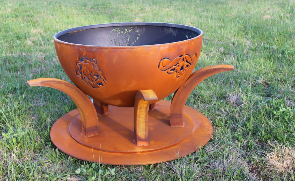 Metal fire pit with African animals cut outs on the sides.