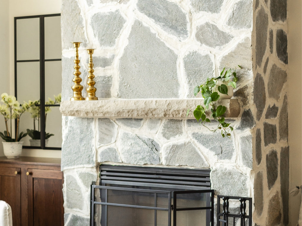 Stone fireplace with cast stone mantel in limestone.