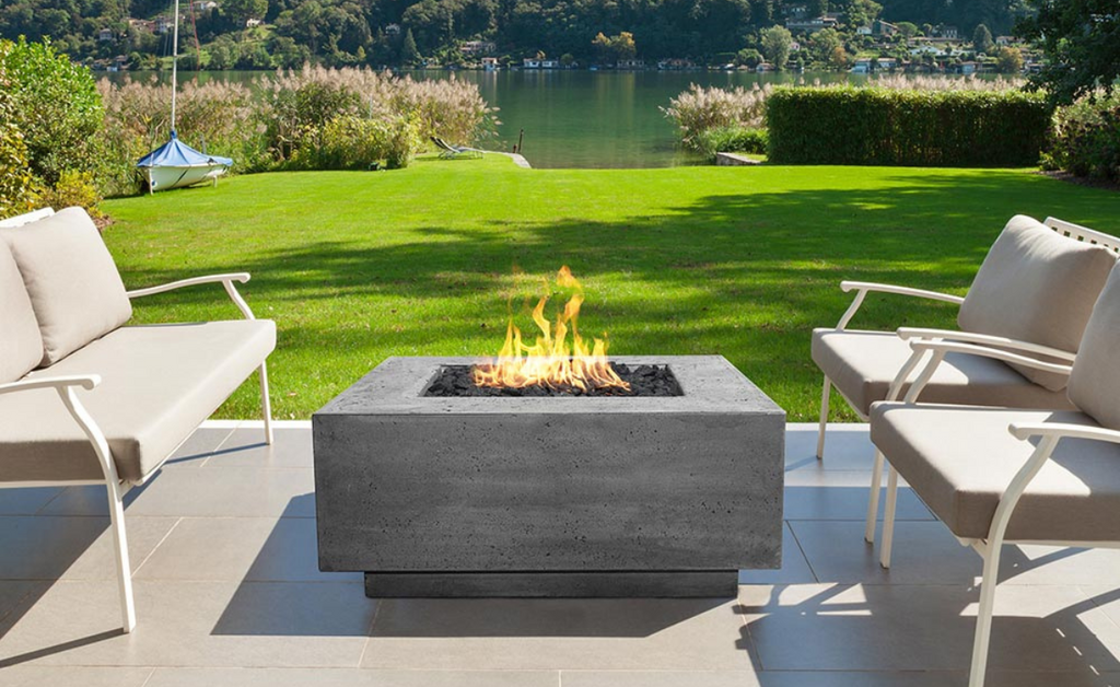 Spacious backyard with patio furniture around a concrete fire pit.