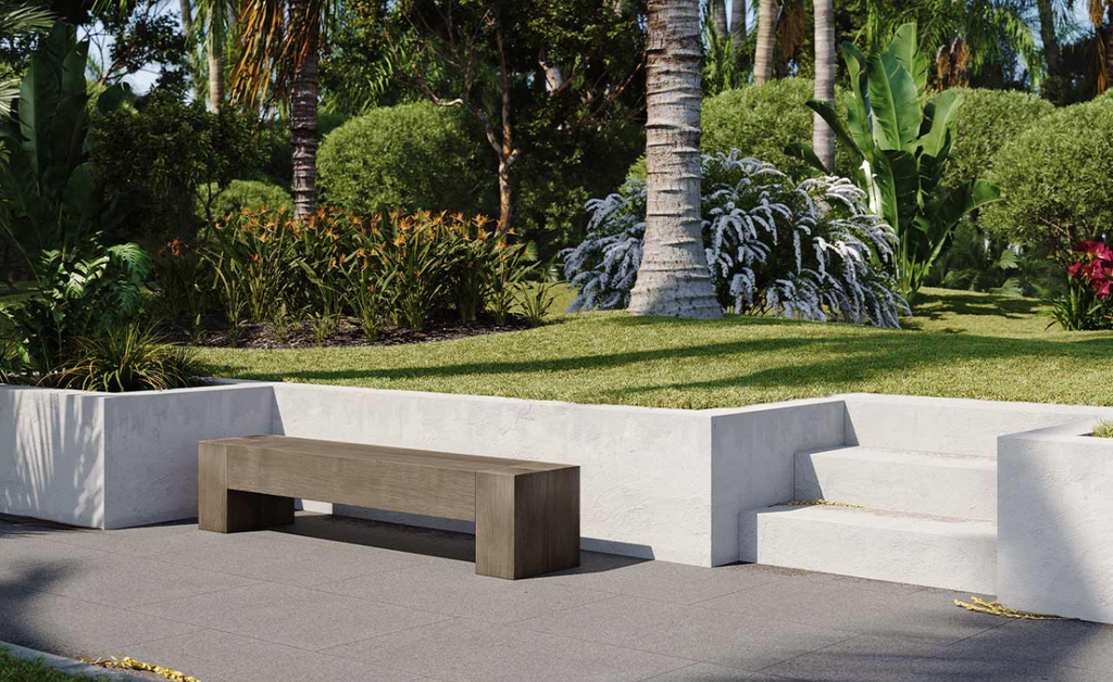 Beautiful backyard with sunken sidewalk and seating area with concrete bench.
