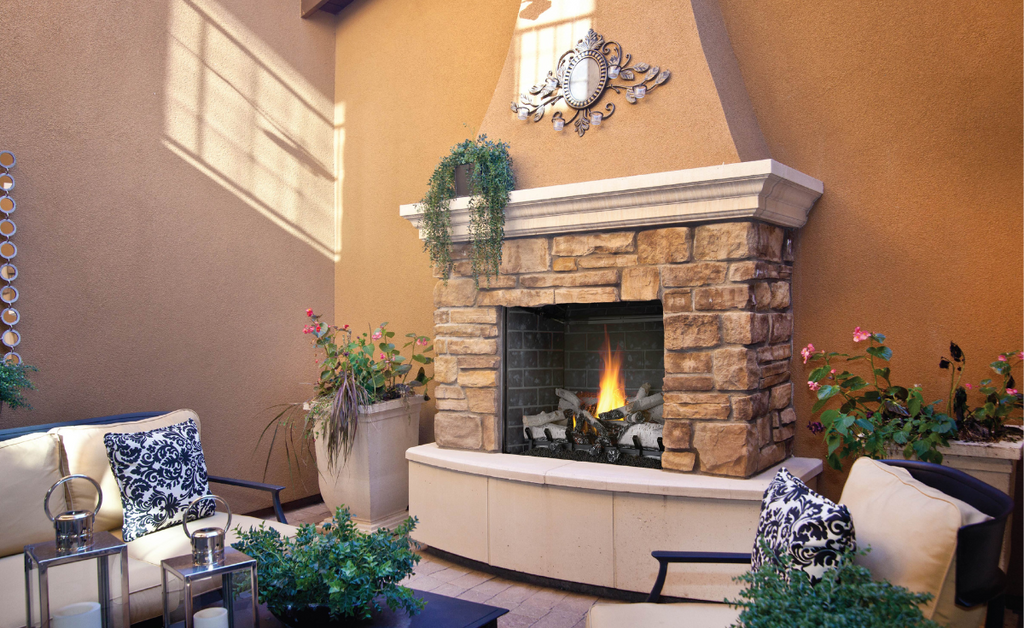 Secluded patio with stone fireplace complete with hearth.