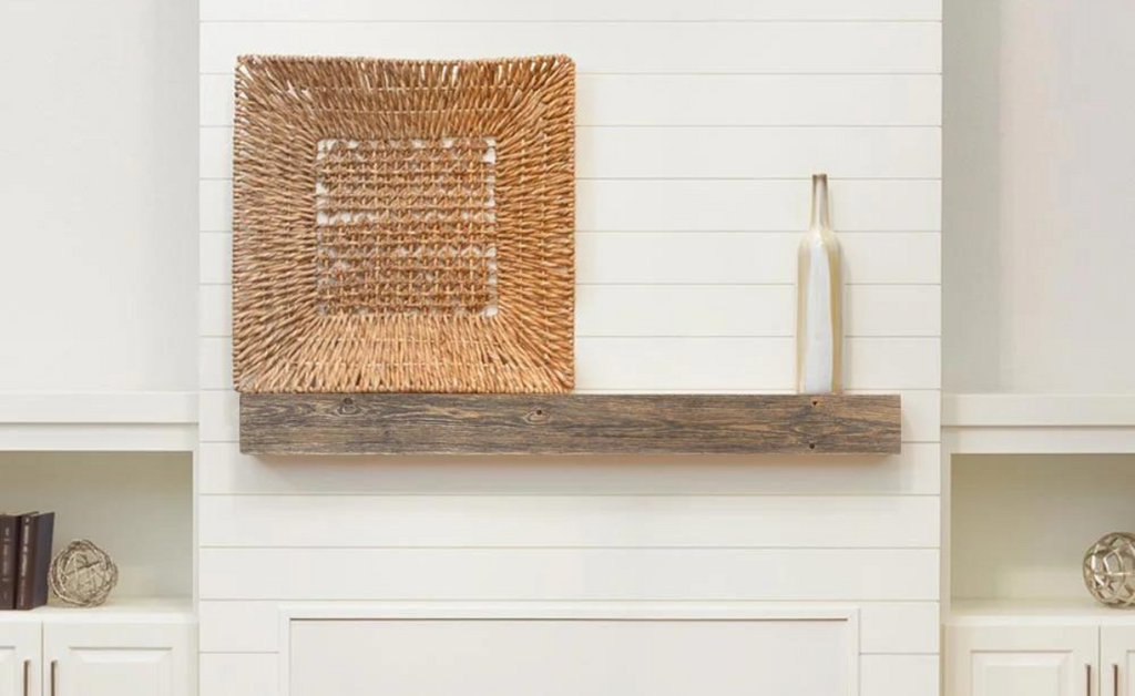 Wood look mantel shelf with large handcrafted basket on top.