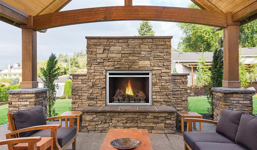 Large stacked stone outdoor fireplace on a patio.