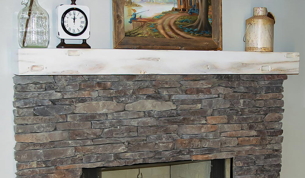 Distressed wood mantel over a stacked stone fireplace surround.