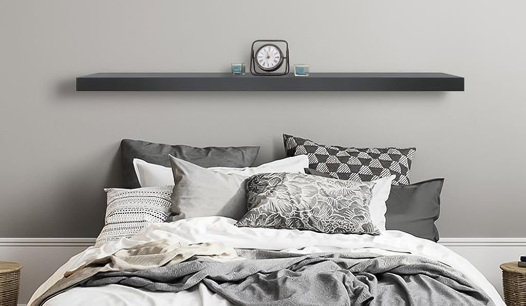 Mantel shelf installed over a bed with clock on top.