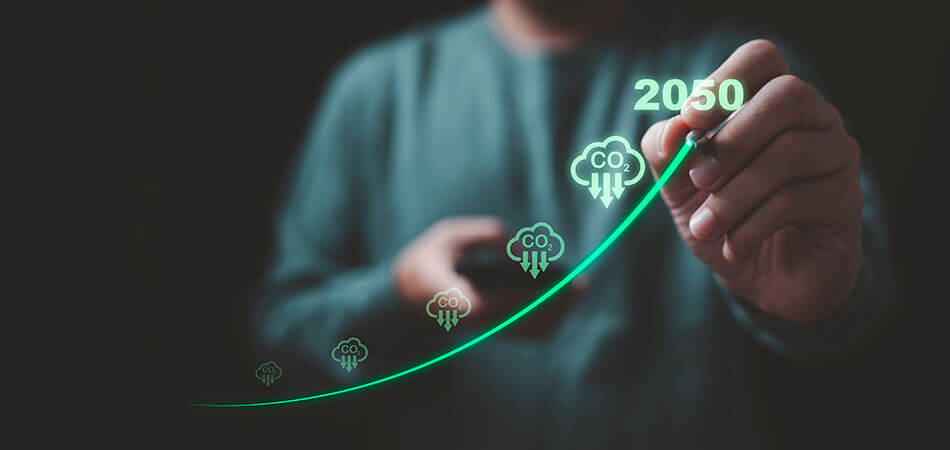 Person looking towards camera drawing a upwards graph to highlight 2050 carbon neutral targets.