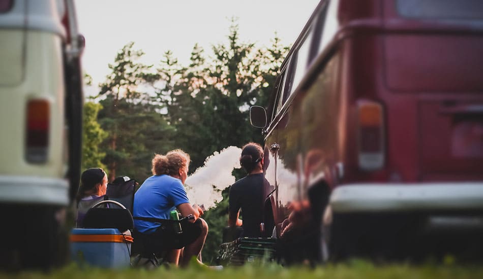 Group of people sat around at a festival vaping e-cigarettes.