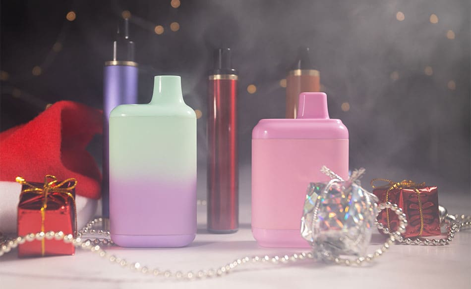 Beginner friendly vape kits on a table surrounded by Christmas decorations and presents.