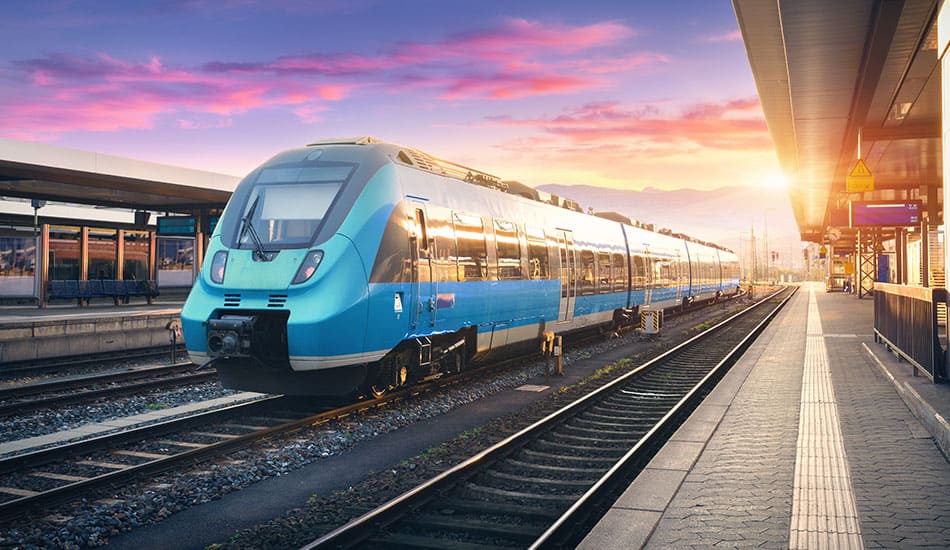 Passenger train sat at a train station platform.