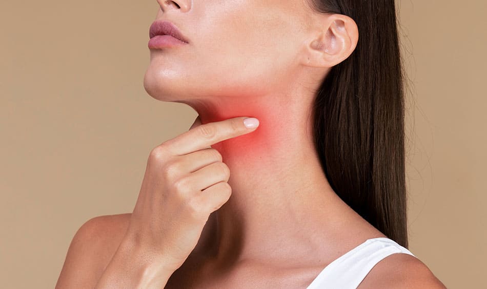 Woman pinching her throat that's highlighted in red.
