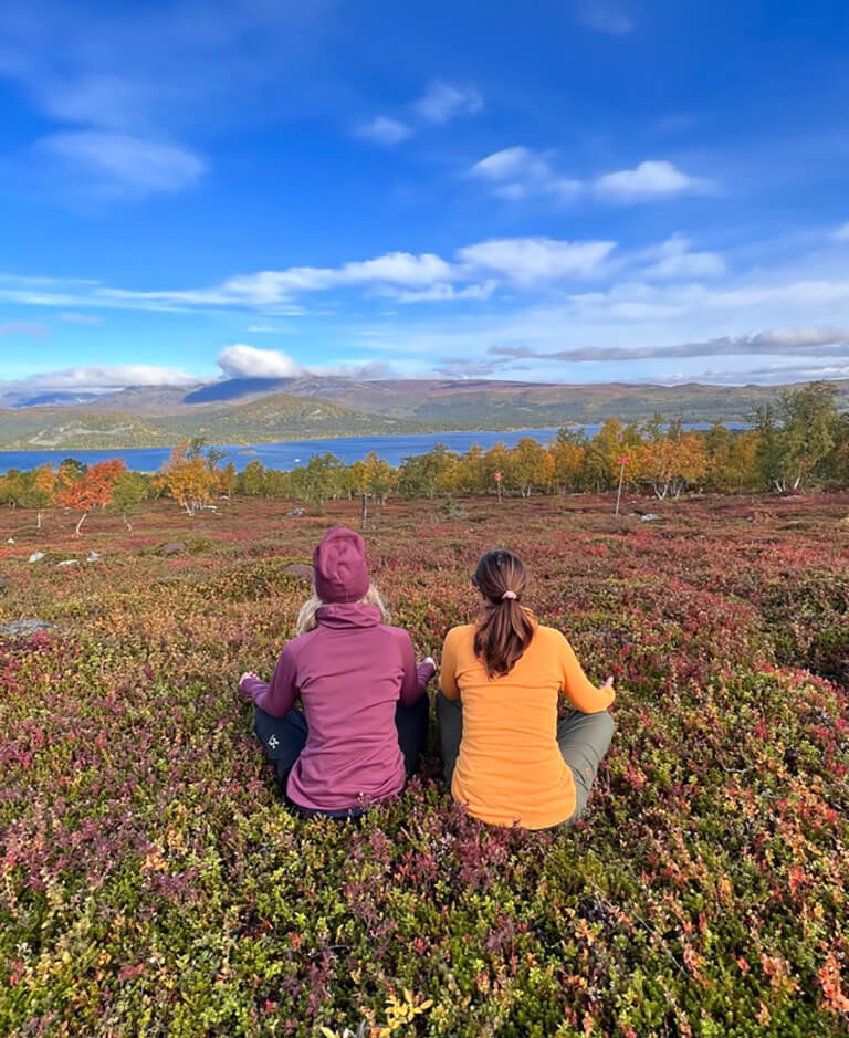 Two women wearing Arctic Legacy clothes in Swedish Lapland