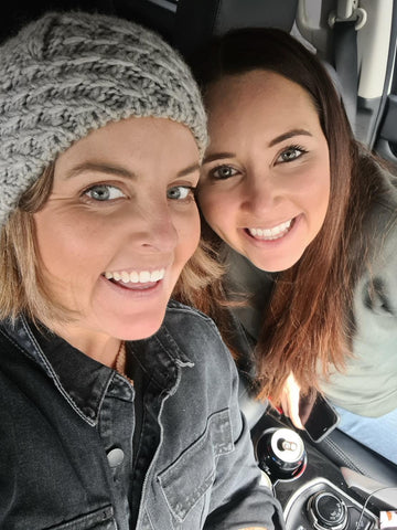 Two women smiling in a car