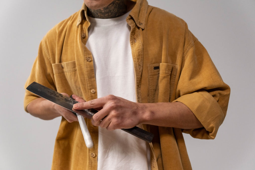 man sharpening knife on a sharpening steel 