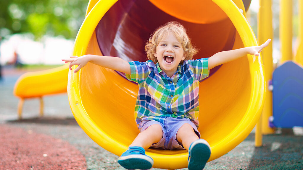 a child on a yellow slide