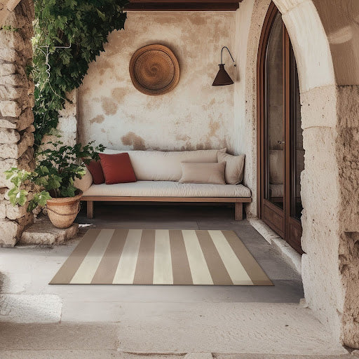 Jute Anika Striped Washable Rug 5'x7' on an outside patio with a couch.