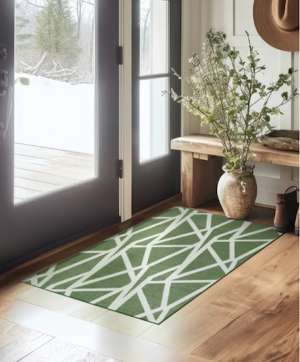 My Magic Carpet x Genevieve Gorder's Intersections Juniper Green washable rug by an entryway.