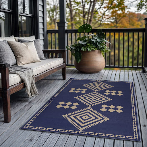 Jute Kilim Kiki Navy Washable Rug 5'x7' on a porch next to a couch and potted plant.