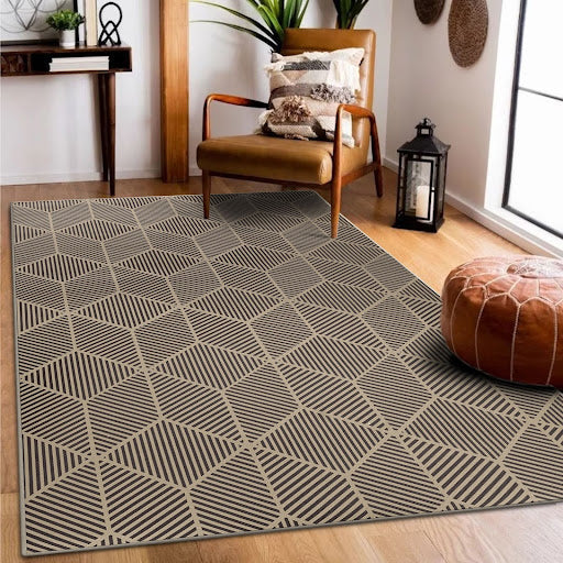 Jute Q-Bert Washable Rug In Natural 5'x7' in a sitting room with a chair and pouf.
