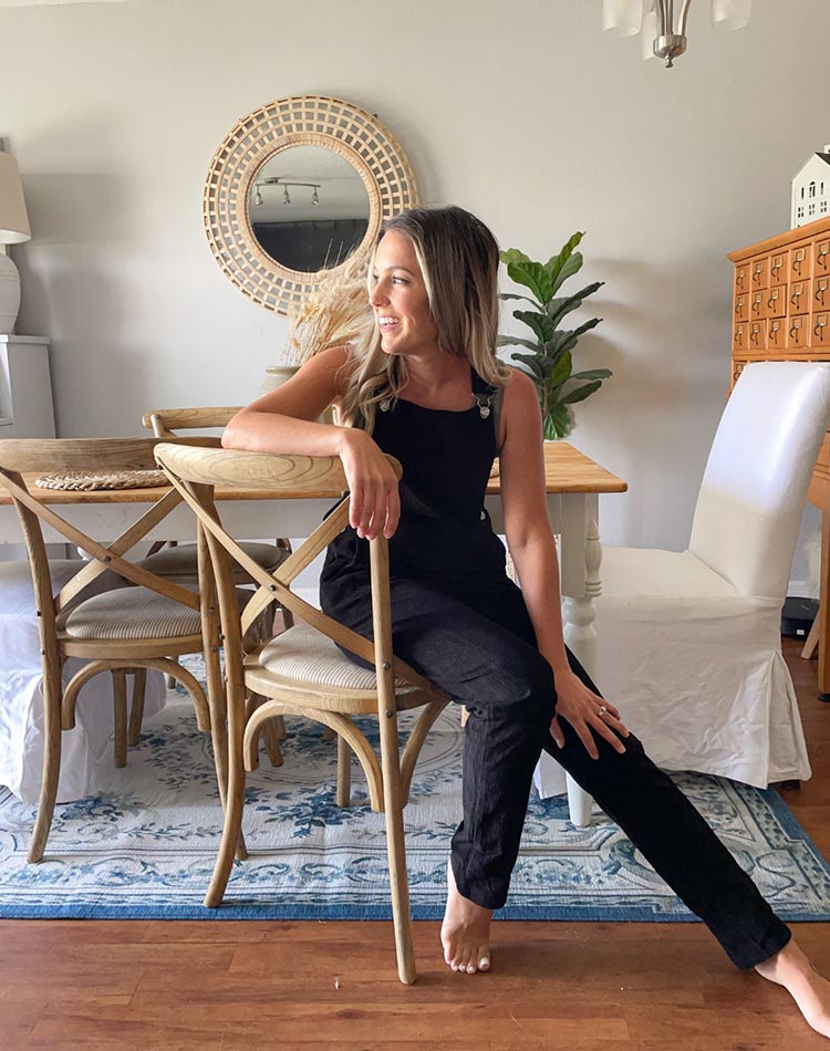 A woman sitting at a dining room table on a My Macic Carpet Aubusson Blue washable rug.