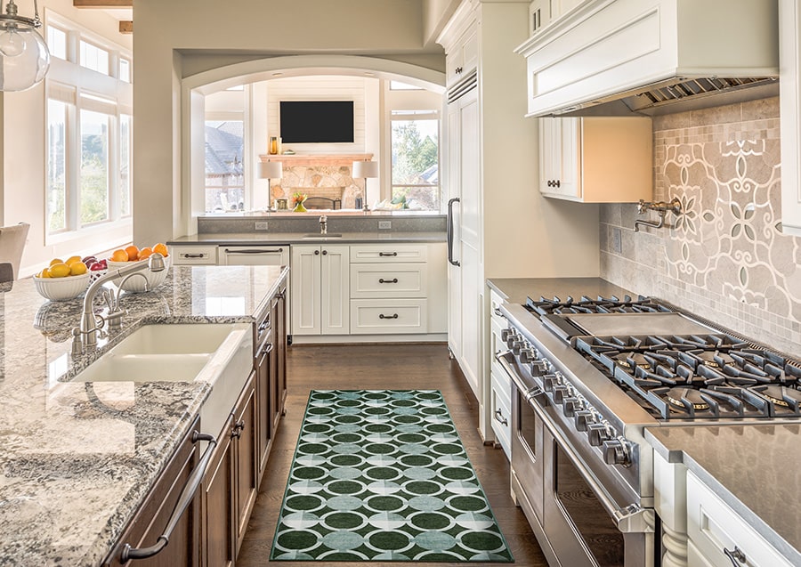 Sage green geometric carpet runner in kitchen. 