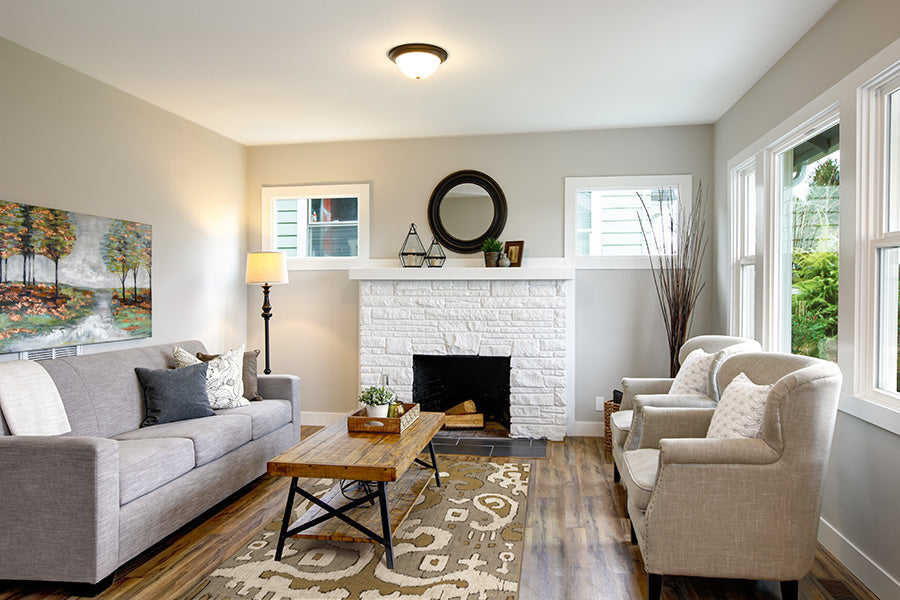 Image of traditional style living room with couches, fireplace, table and area rug.