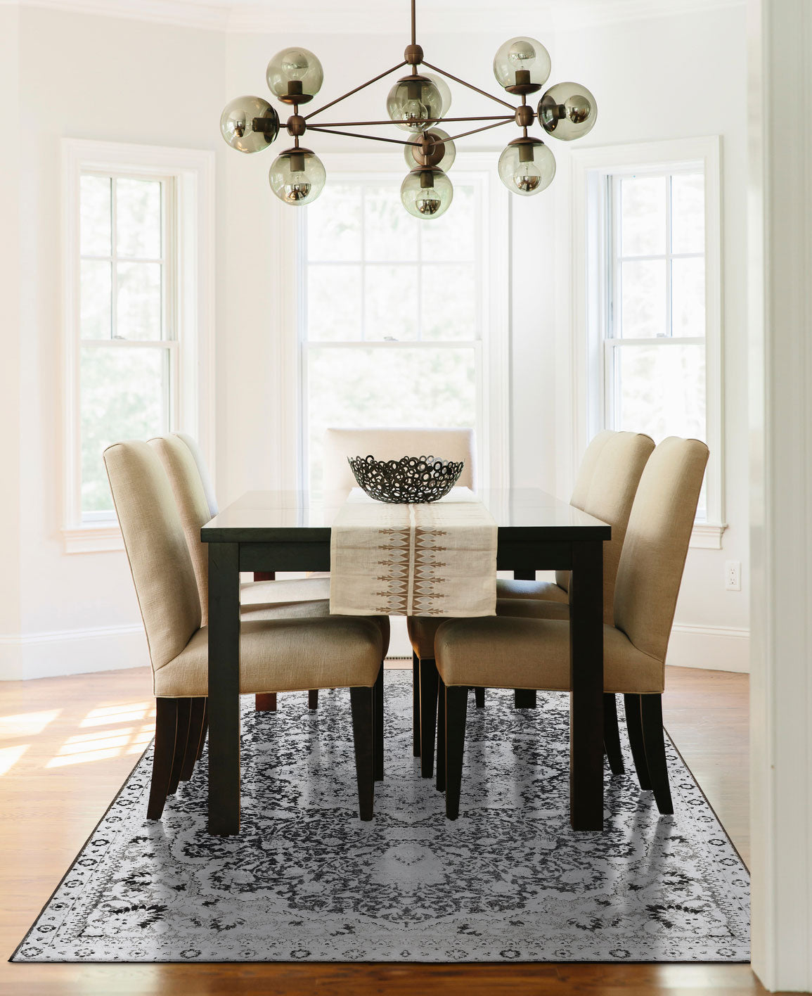 A dining room with My Magic Carpet's 6'x9' Parviz Grey washable rug.