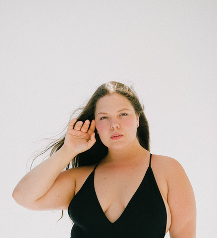 plus size woman in a black one-piece swimsuit