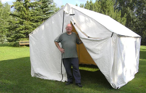 Man standing in front of tent.