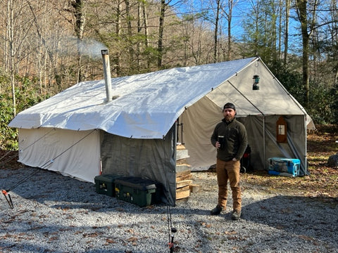 Man standing next to tent