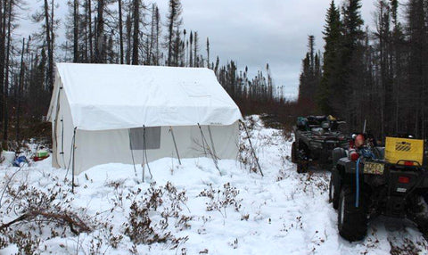 Canvas Tent in snow with 4 wheelers