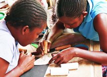 Ladies creating a bead design on leather