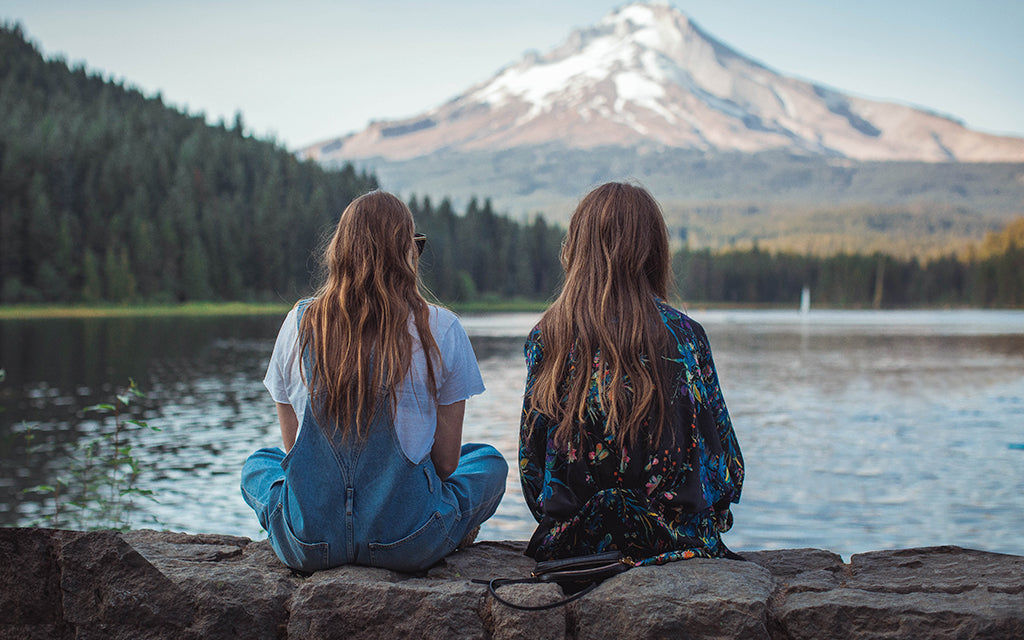 Two women in front of a lake