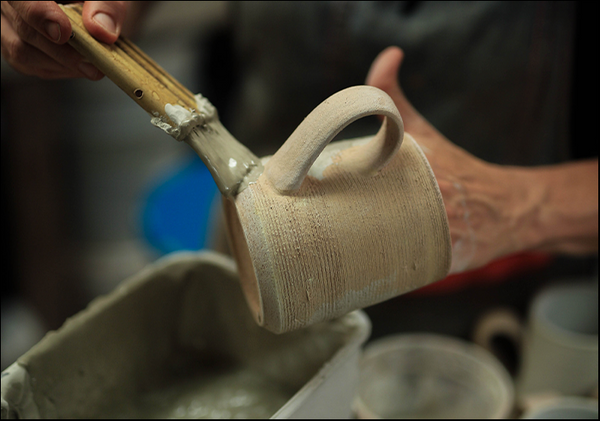 Brushing glaze on by hand