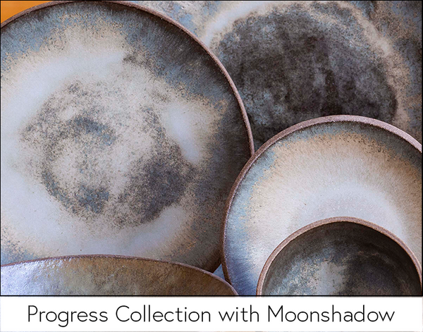 Plates and bowls displaying variations of Moonshadow glaze on the Progress Collection