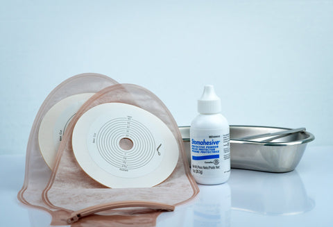 ostomy supplies, ostomy deodorant drops and a surgical tray and scissors