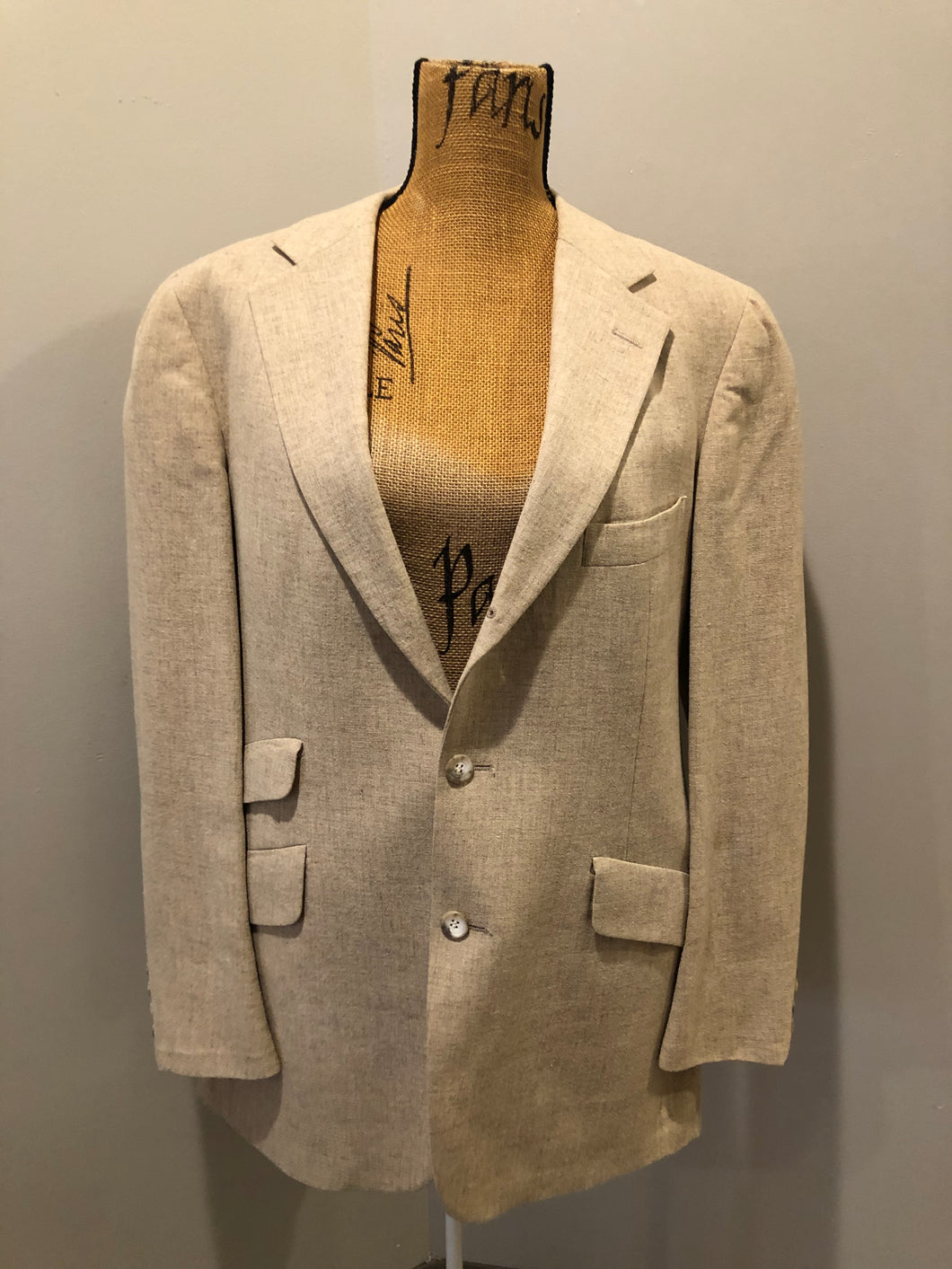 Kingspier Vintage - Chaps by Ralph Lauren light beige two piece suit sold at Martini Carl Boston. Jacket is a three button notch lapel with three flap pockets and a breast pocket. The pants are flat front with two slash pockets, a tiny flap pocket in the front and two back pockets.